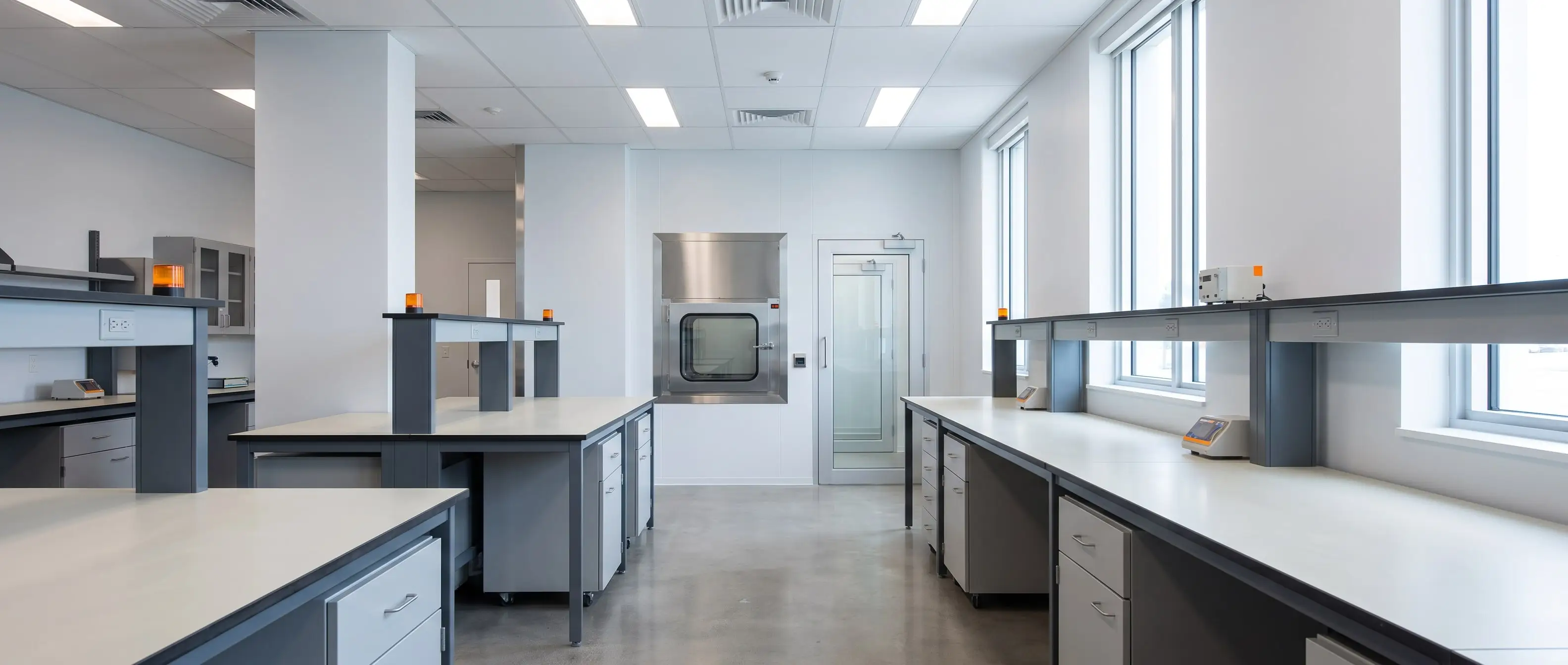Corridor view into a modern laboratory with cleanroom pass box, straight verticals